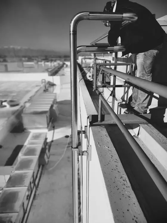 Custom stainless steel rooftop handrail and guardrail fabricated and installed by Wetzel Welding