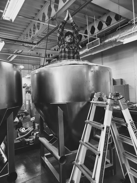 Wetzel Welding technician installing large stainless steel process vessels in a production facility
