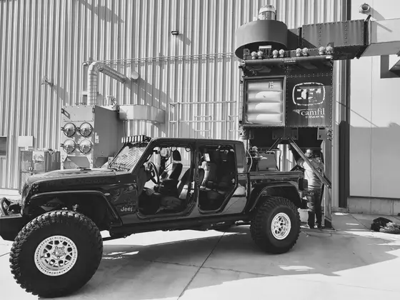 Wetzel Welding fabrication shop exterior with a vehicle parked beside the equipment bay