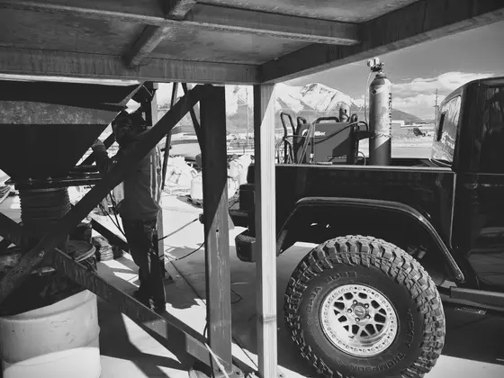 Wetzel Welding service truck parked at a job site with Utah mountains in the distance