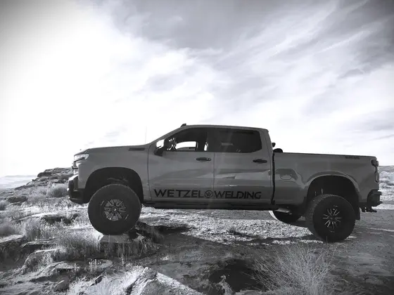 Wetzel Welding branded work truck parked on rugged Utah desert terrain