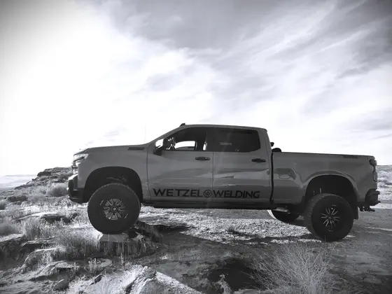 Wetzel Welding branded work truck parked on rugged Utah desert terrain