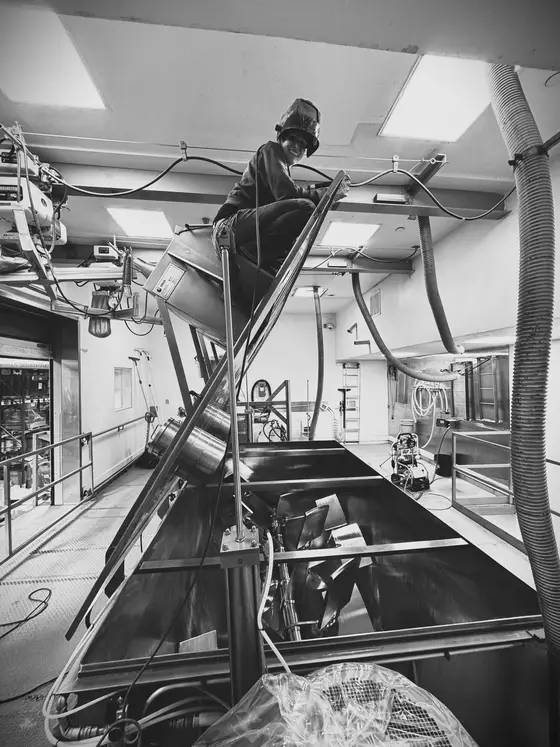 Wetzel Welding technician servicing stainless steel processing equipment from an elevated platform